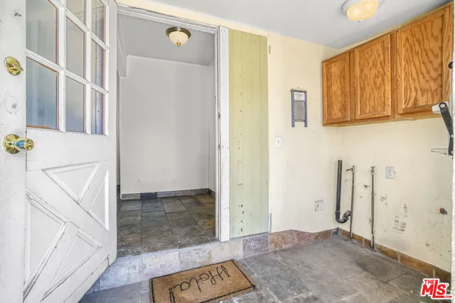 view of room with window and hallway