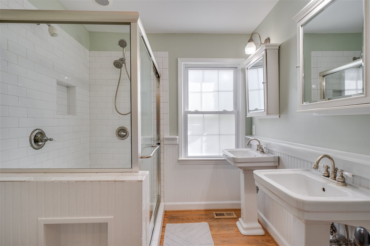1219 Clifton Street Raleigh, NC 27604 - Photo 16 of 30 Subway tile shower with glass walls/door. Dual pedestal vanities, hardwood floors. Master Bath