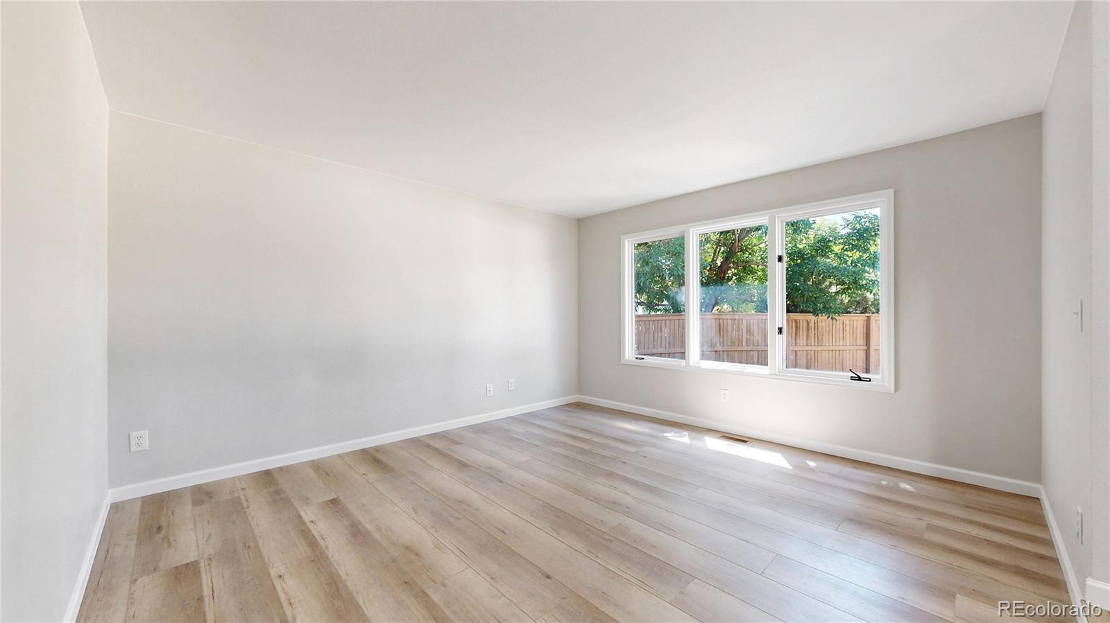 6265 Cornell Court Highlands Ranch, CO 80130 - Photo 11 of 41 an empty room with wooden floor and windows