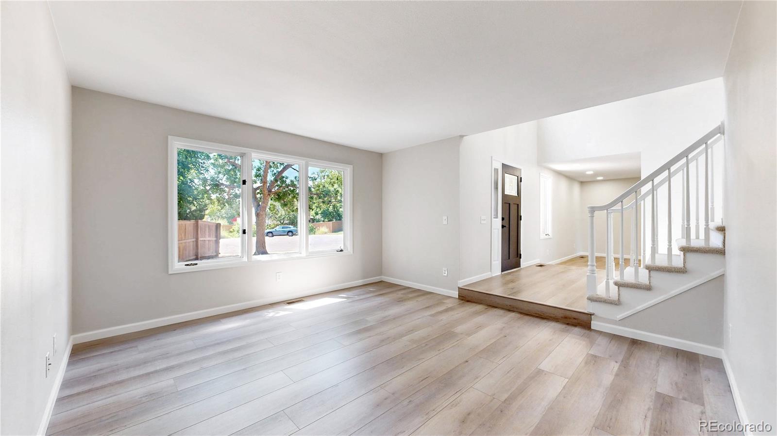 6265 Cornell Court Highlands Ranch, CO 80130 - Photo 12 of 41 a view of an empty room with wooden floor and a window