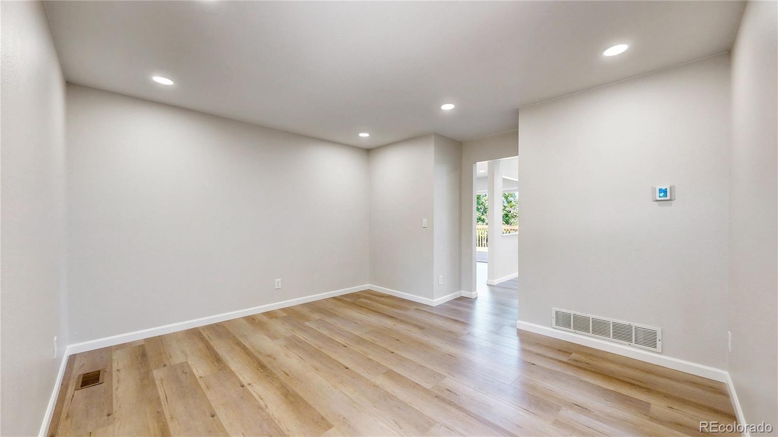 6265 Cornell Court Highlands Ranch, CO 80130 - Photo 13 of 41 en empty room with wooden floor