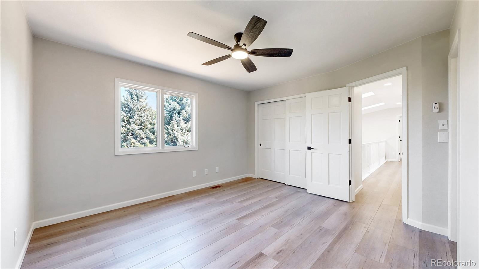 6265 Cornell Court Highlands Ranch, CO 80130 - Photo 20 of 41 wooden floor in an empty room with a window