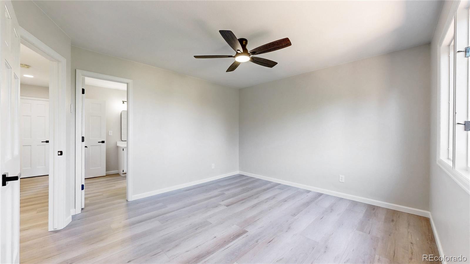6265 Cornell Court Highlands Ranch, CO 80130 - Photo 21 of 41 an empty room with wooden floor and windows