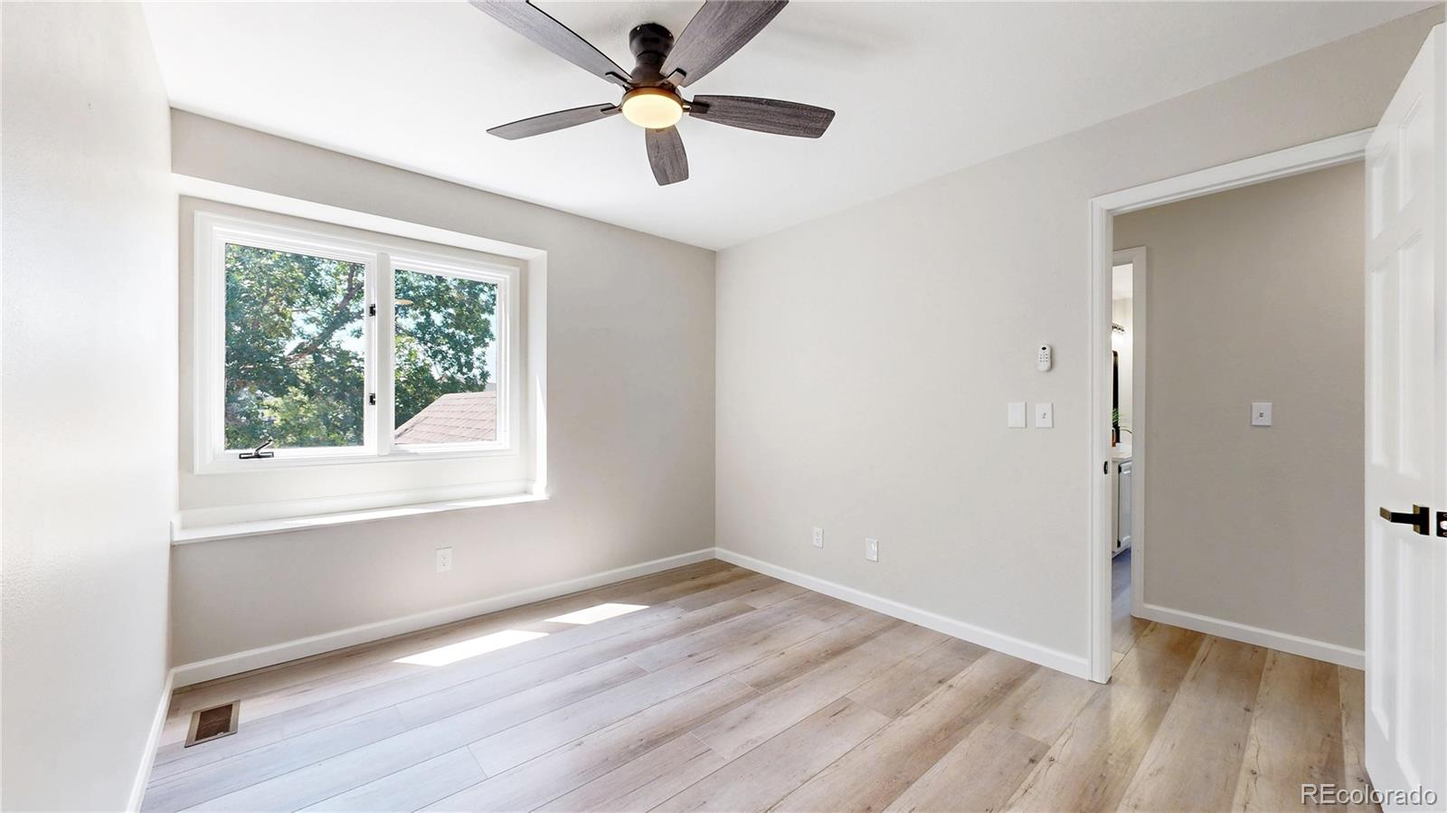 6265 Cornell Court Highlands Ranch, CO 80130 - Photo 22 of 41 a view of empty room with wooden floor and fan