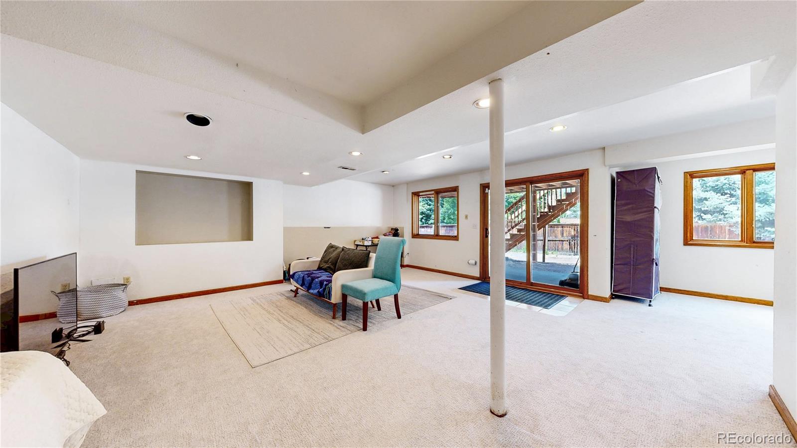 6265 Cornell Court Highlands Ranch, CO 80130 - Photo 26 of 41 a living room with furniture gym equipment and a large window