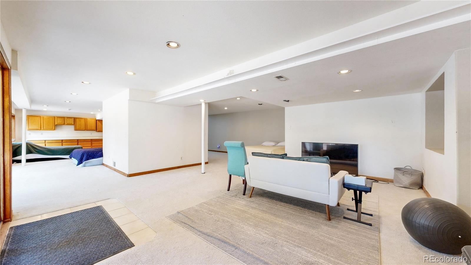 6265 Cornell Court Highlands Ranch, CO 80130 - Photo 27 of 41 a living room with furniture and a flat screen tv
