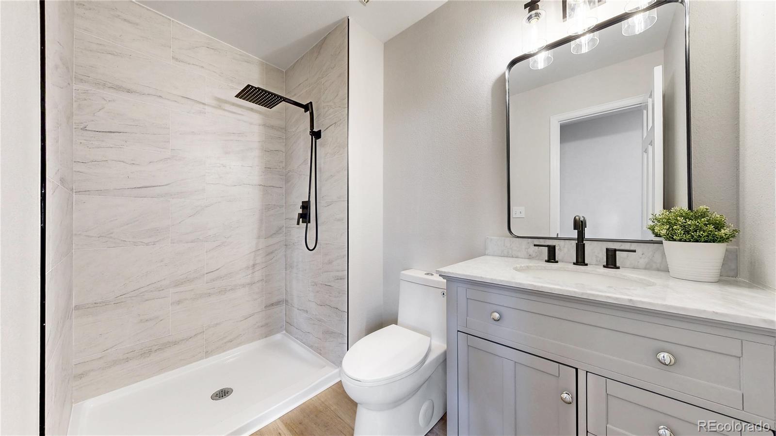 6265 Cornell Court Highlands Ranch, CO 80130 - Photo 8 of 41 a bathroom with a granite countertop sink toilet and shower