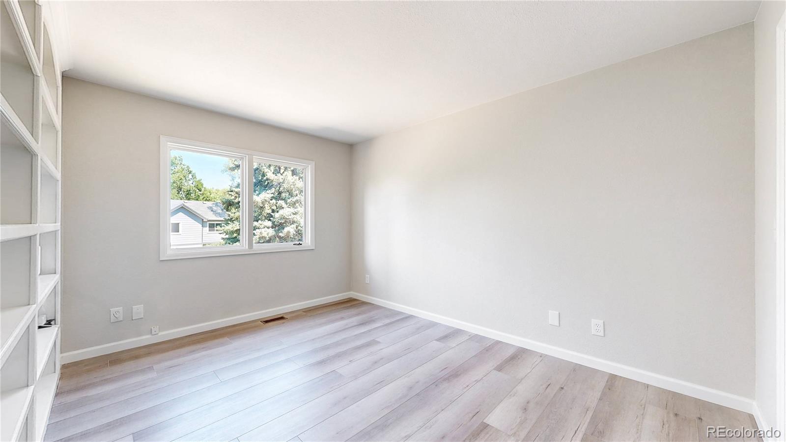 6265 Cornell Court Highlands Ranch, CO 80130 - Photo 9 of 41 an empty room with wooden floor and window