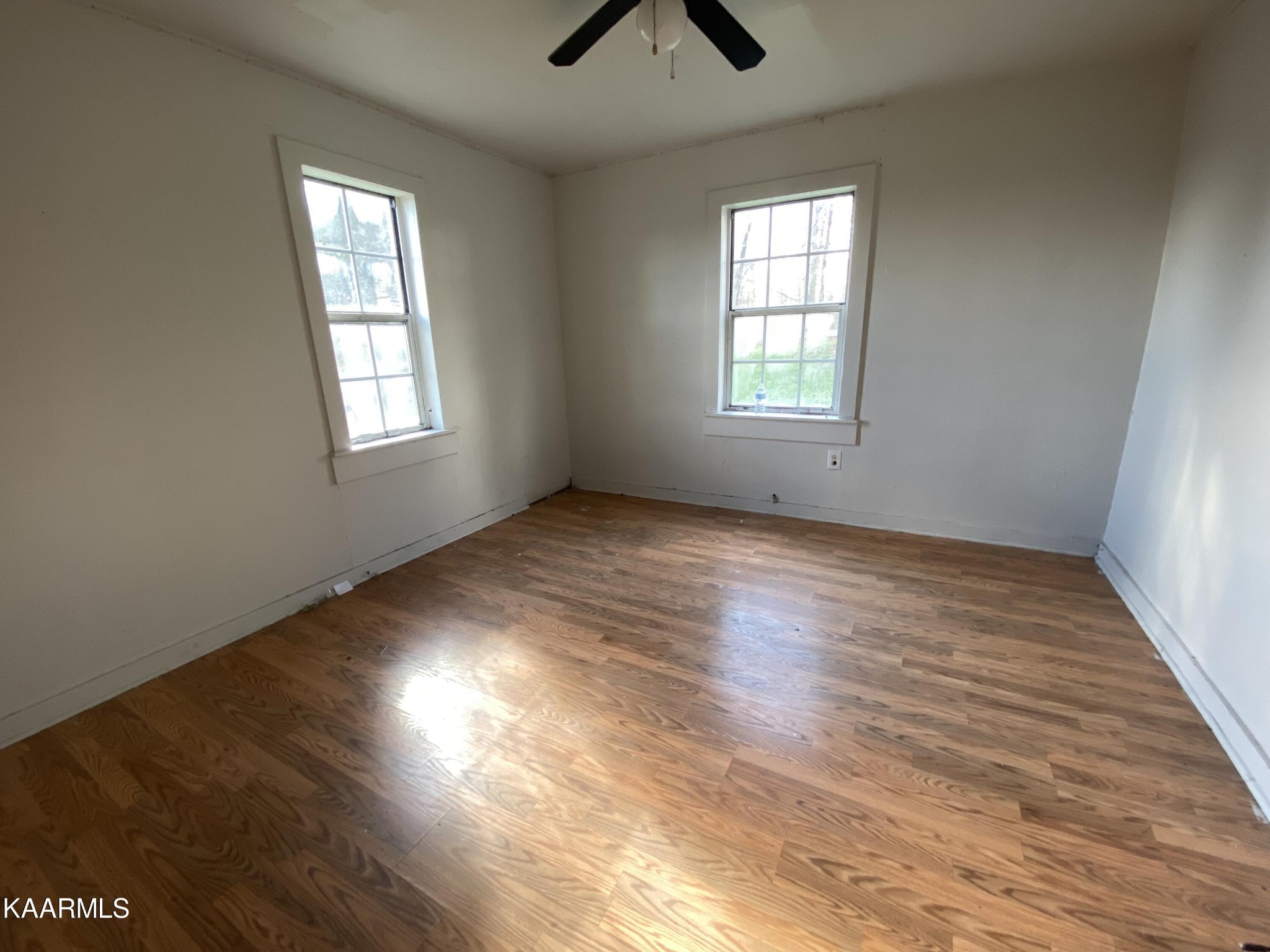 436 Fox Creek Road Crossville, TN 38571 - Photo 18 of 22 an empty room with wooden floor and windows