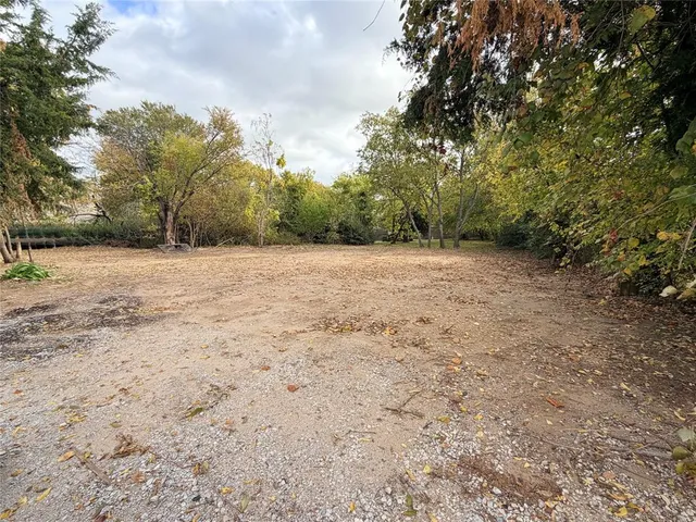 a backyard of a house with large trees