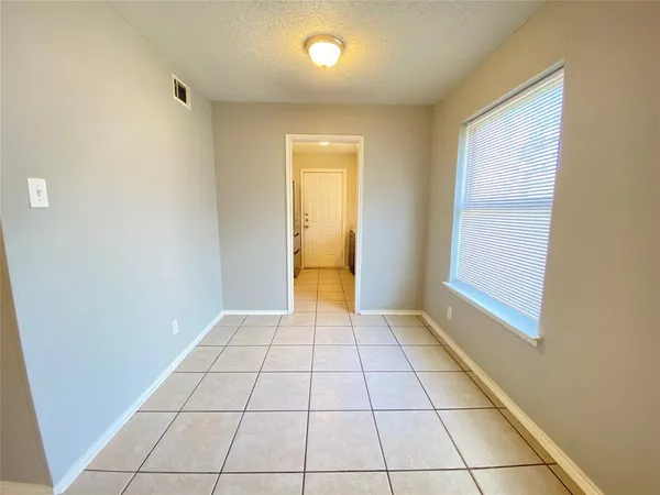 a view of an empty room with glass door