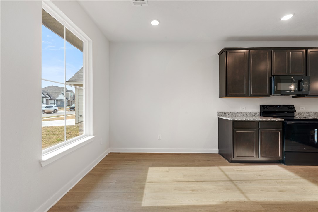 2412 Rooke Road Bryan, TX 77807 - Photo 7 of 35 a view of kitchen with granite countertop cabinets and black appliances
