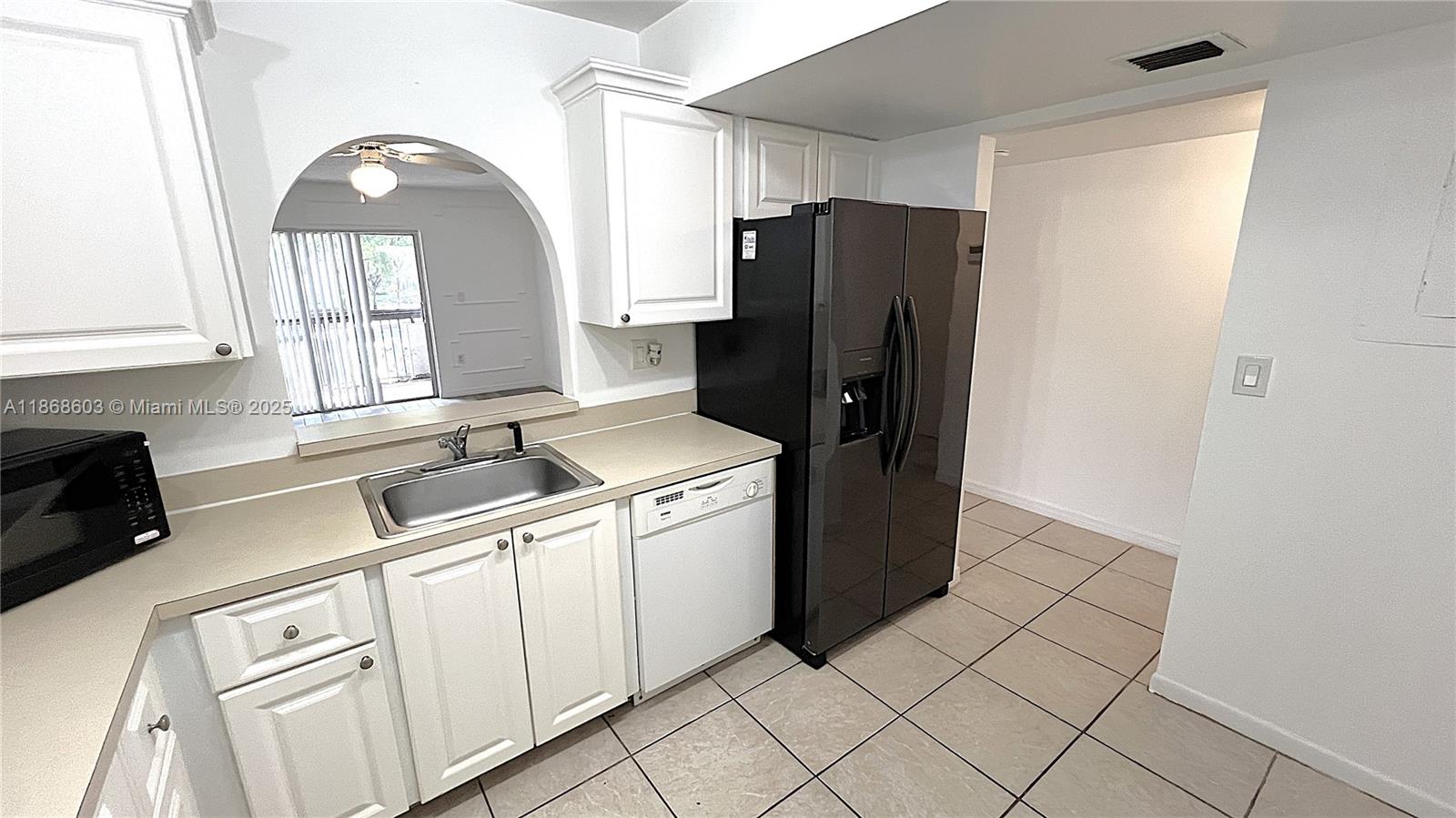 711 North Pine Island Road, Unit 211 Plantation, FL 33324 - Photo 4 of 16 a kitchen with a refrigerator sink and cabinets