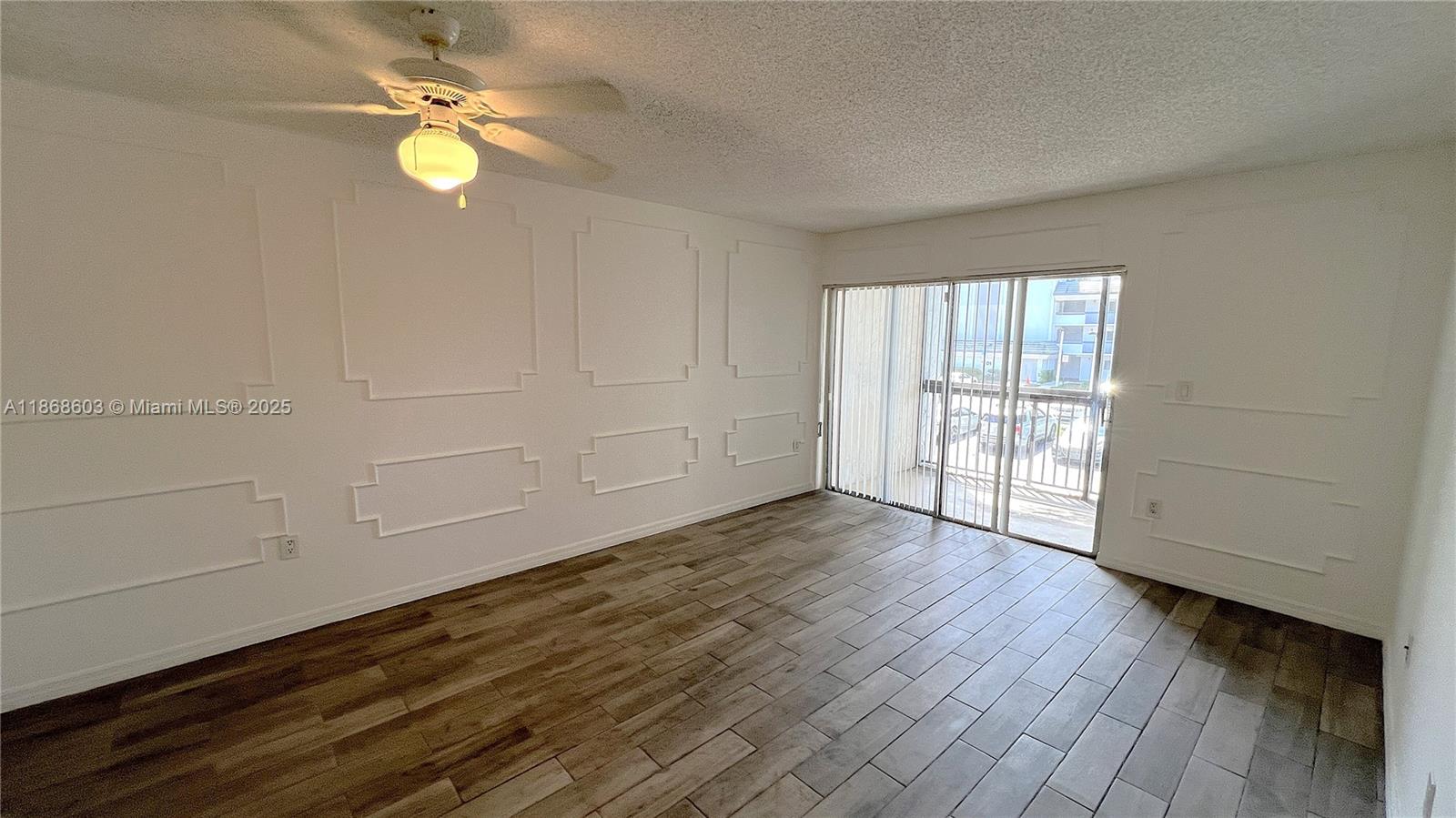 711 North Pine Island Road, Unit 211 Plantation, FL 33324 - Photo 7 of 16 an empty room with wooden floor cabinet and windows