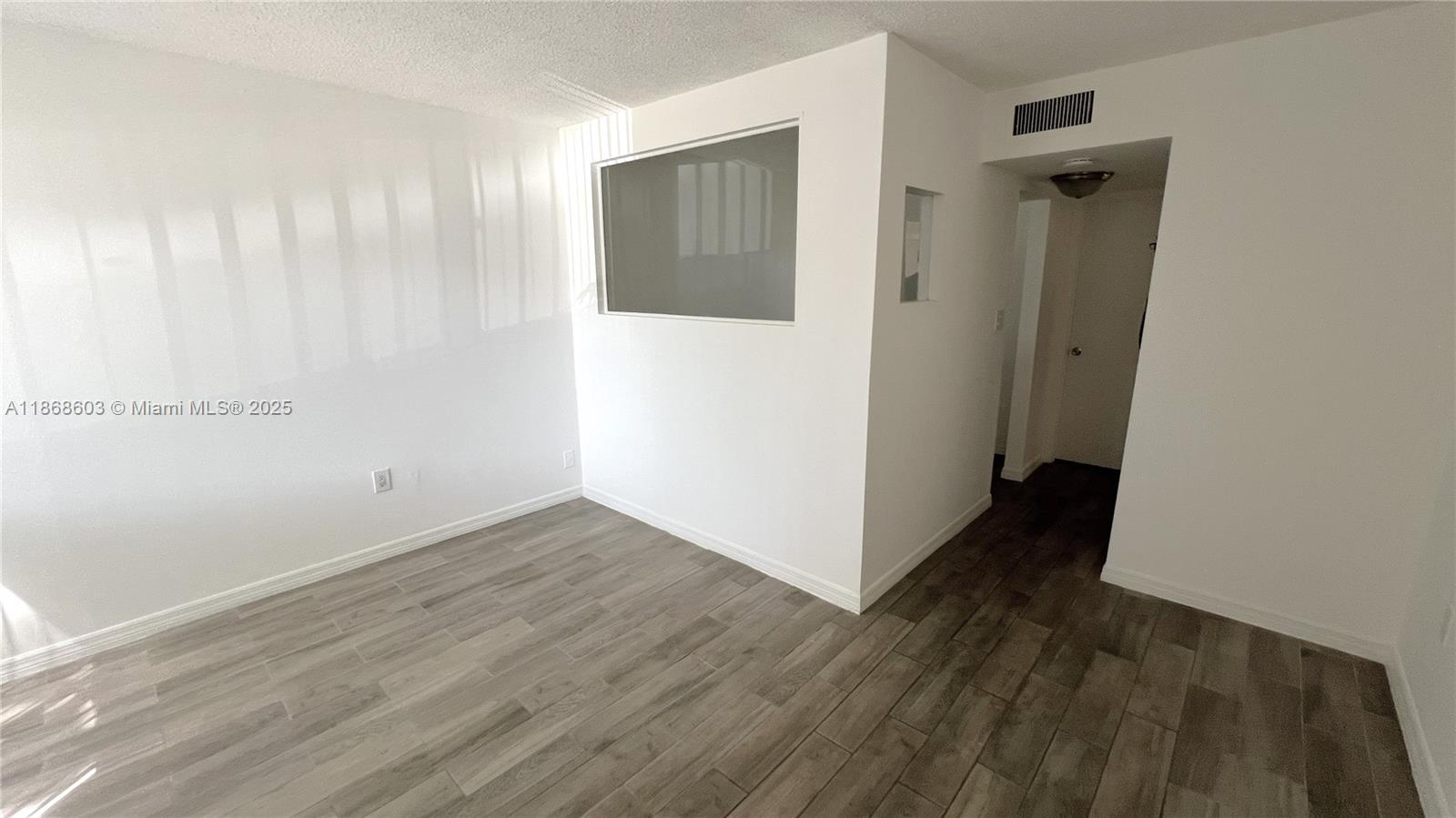 711 North Pine Island Road, Unit 211 Plantation, FL 33324 - Photo 9 of 16 an empty room with wooden floor and a ceiling fan
