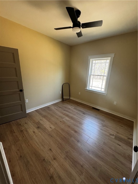 239 Bumpass Road Bumpass, VA 23024 - Photo 17 of 19 a view of an empty room with wooden floor and a window