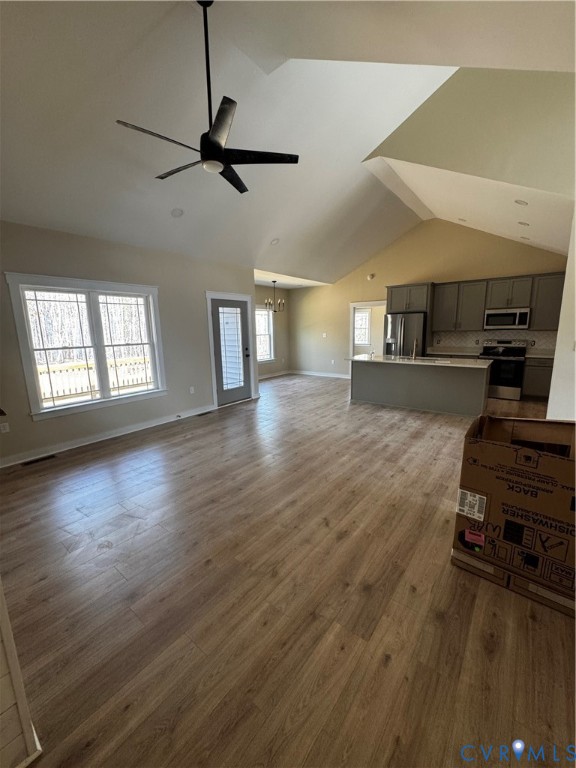 239 Bumpass Road Bumpass, VA 23024 - Photo 18 of 19 a view of a livingroom with wooden floor and a ceiling fan