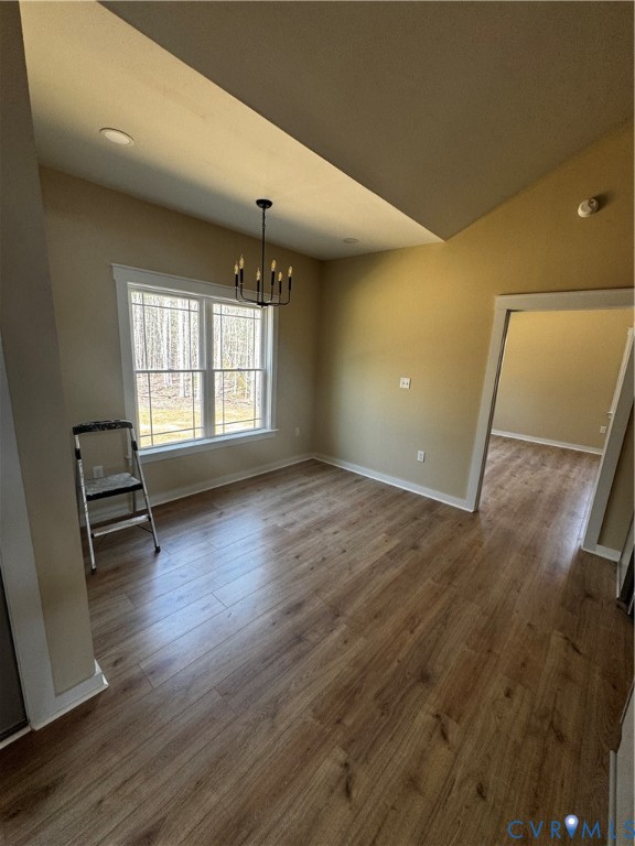 239 Bumpass Road Bumpass, VA 23024 - Photo 5 of 19 an empty room with wooden floor and windows