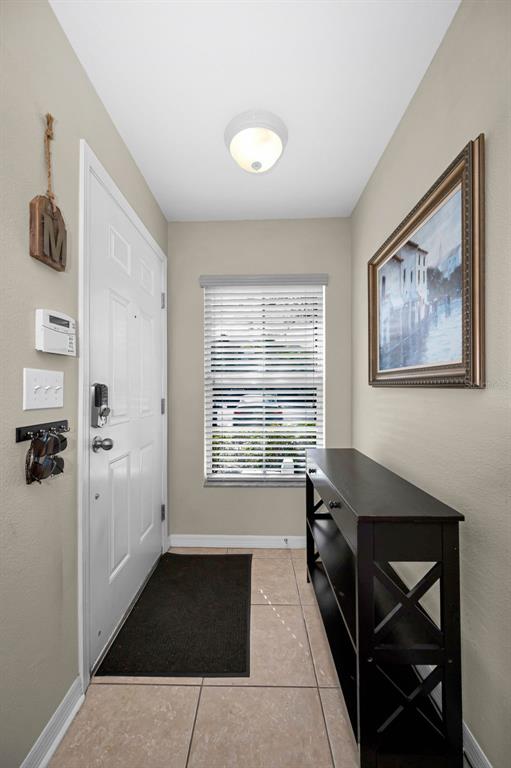 9736 Trumpet Vine Loop Trinity, FL 34655 - Photo 15 of 35 a view of a hallway to a livingroom with furniture and windows