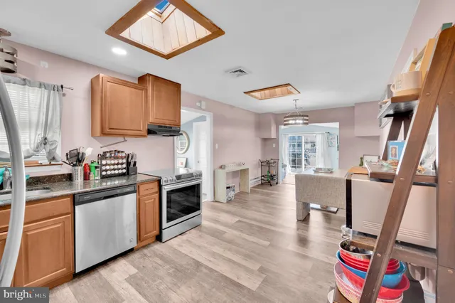 a kitchen with granite countertop a sink appliances and cabinets