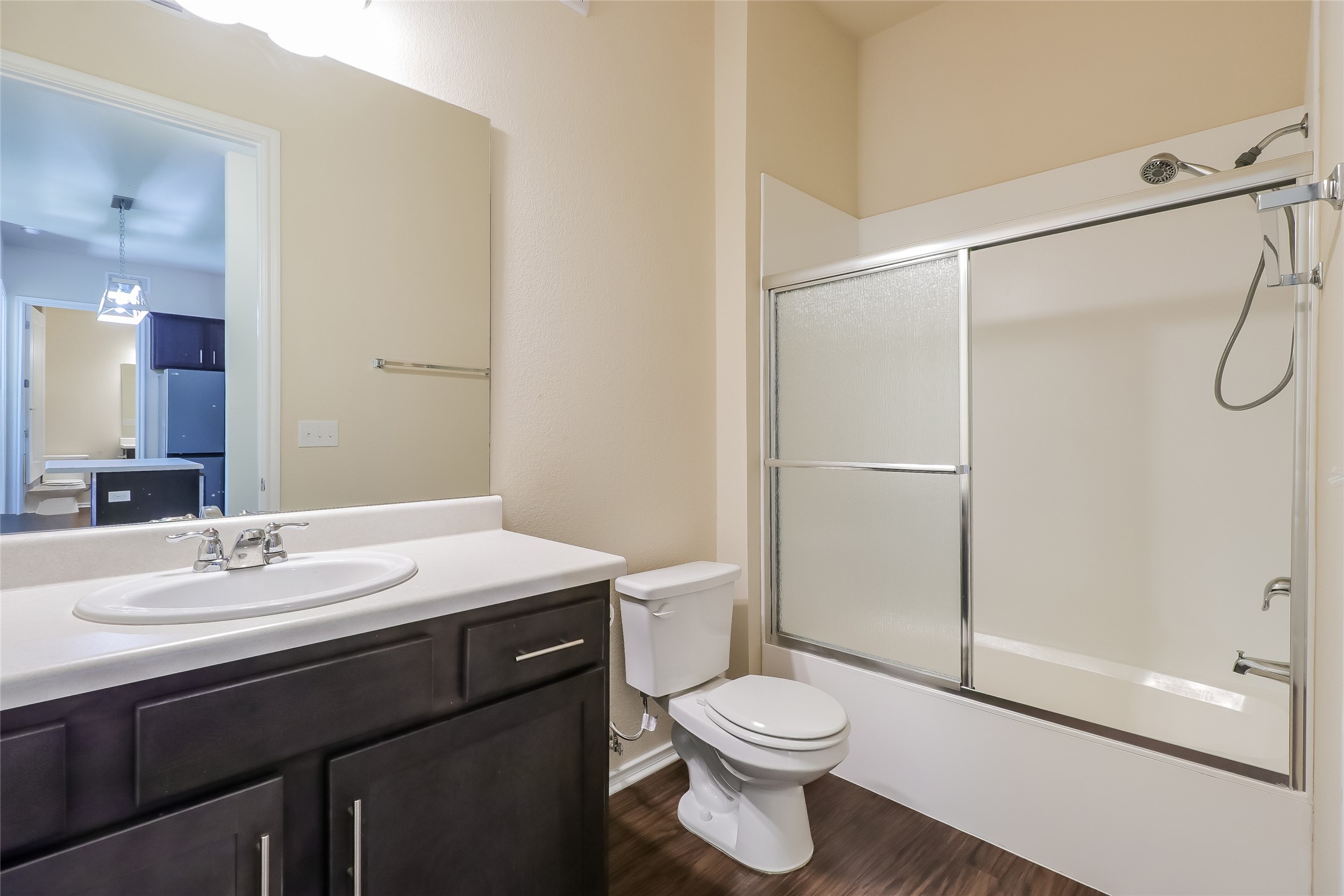 8601 West Gate Boulevard, Unit 7101 Austin, TX 78745 - Photo 15 of 16 Full bathroom with vanity, enclosed tub / shower combo, and dark wood-style floors