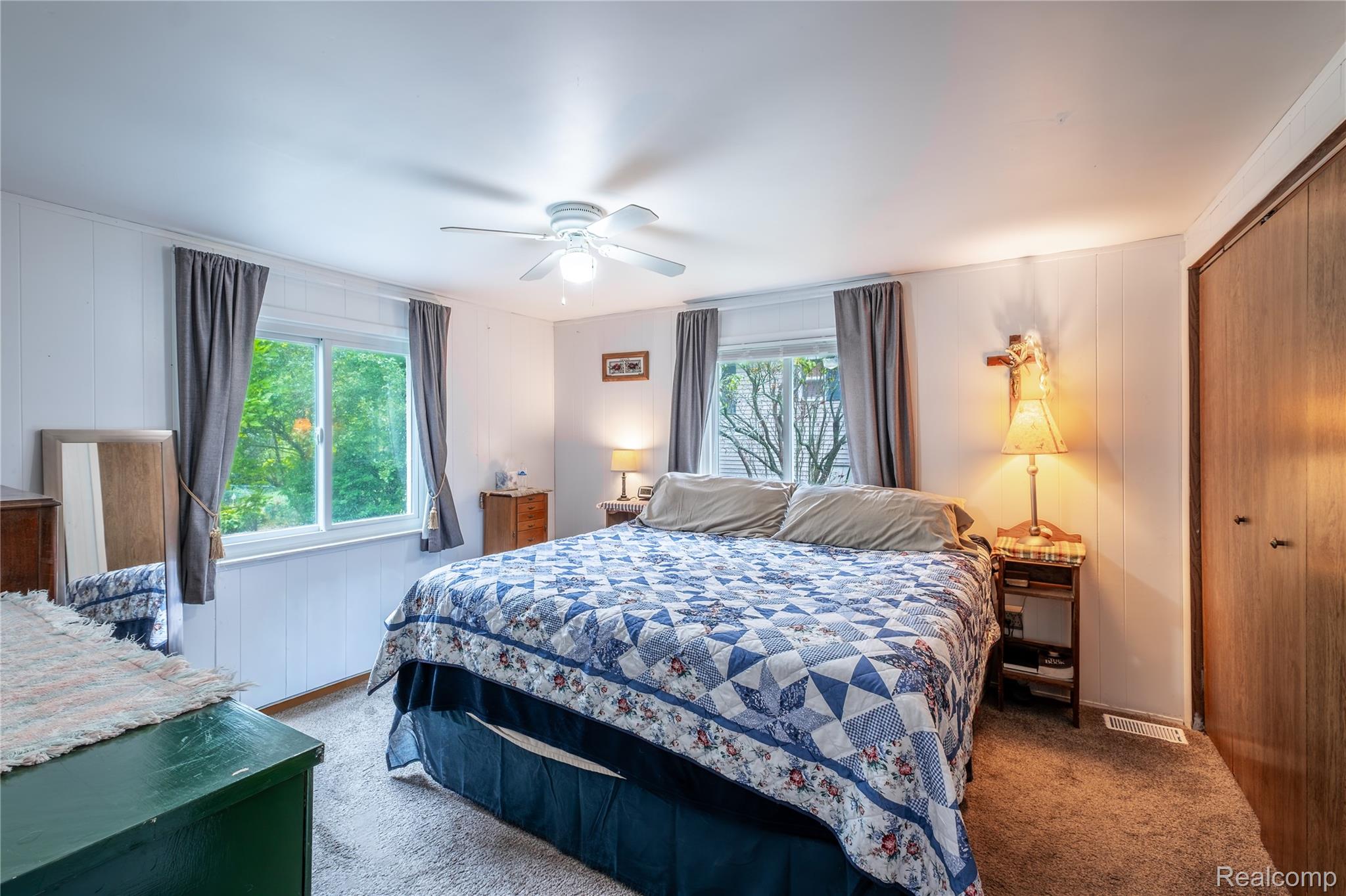 535 Snyder Road Highland, MI 48357 - Photo 11 of 23 White paneled walls, carpeted flooring, and a ceiling fan with integrated lighting