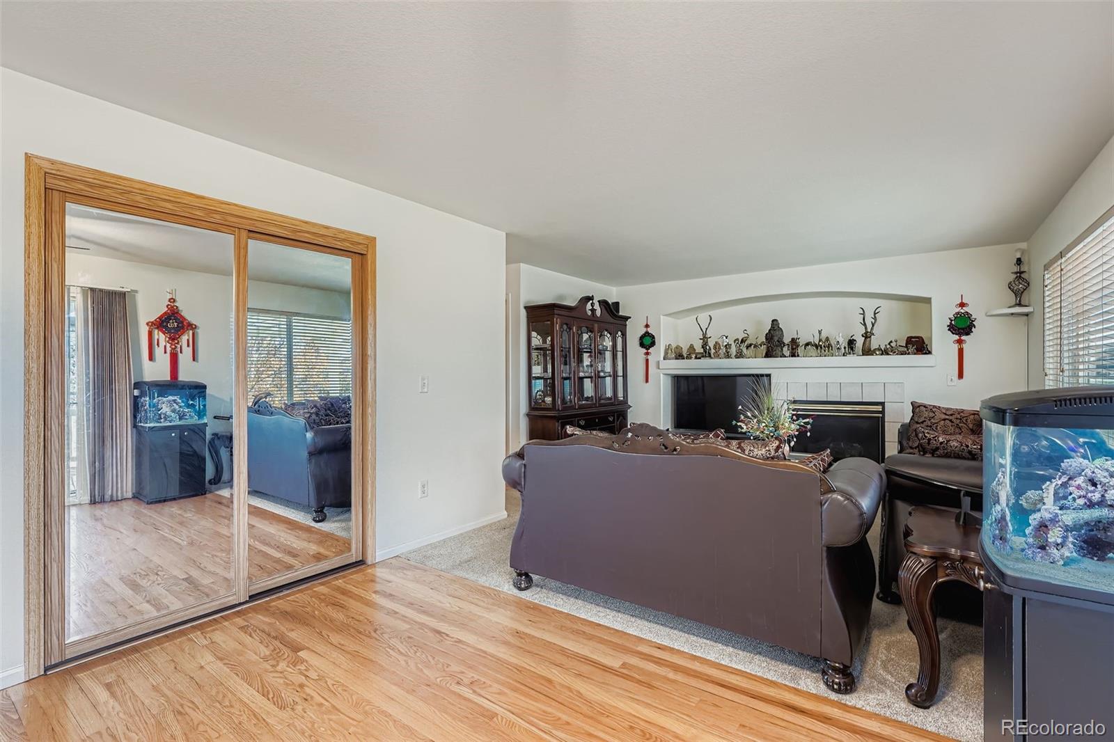 2743 South Waco Way Aurora, CO 80013 - Photo 13 of 28 a living room with furniture and a fireplace