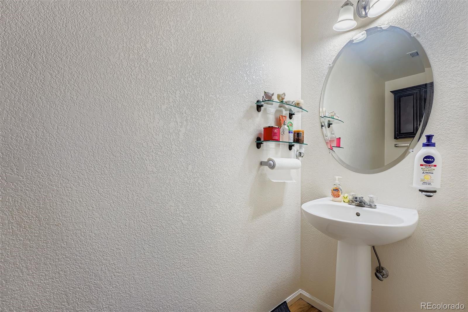2743 South Waco Way Aurora, CO 80013 - Photo 14 of 28 a bathroom with a sink and a mirror