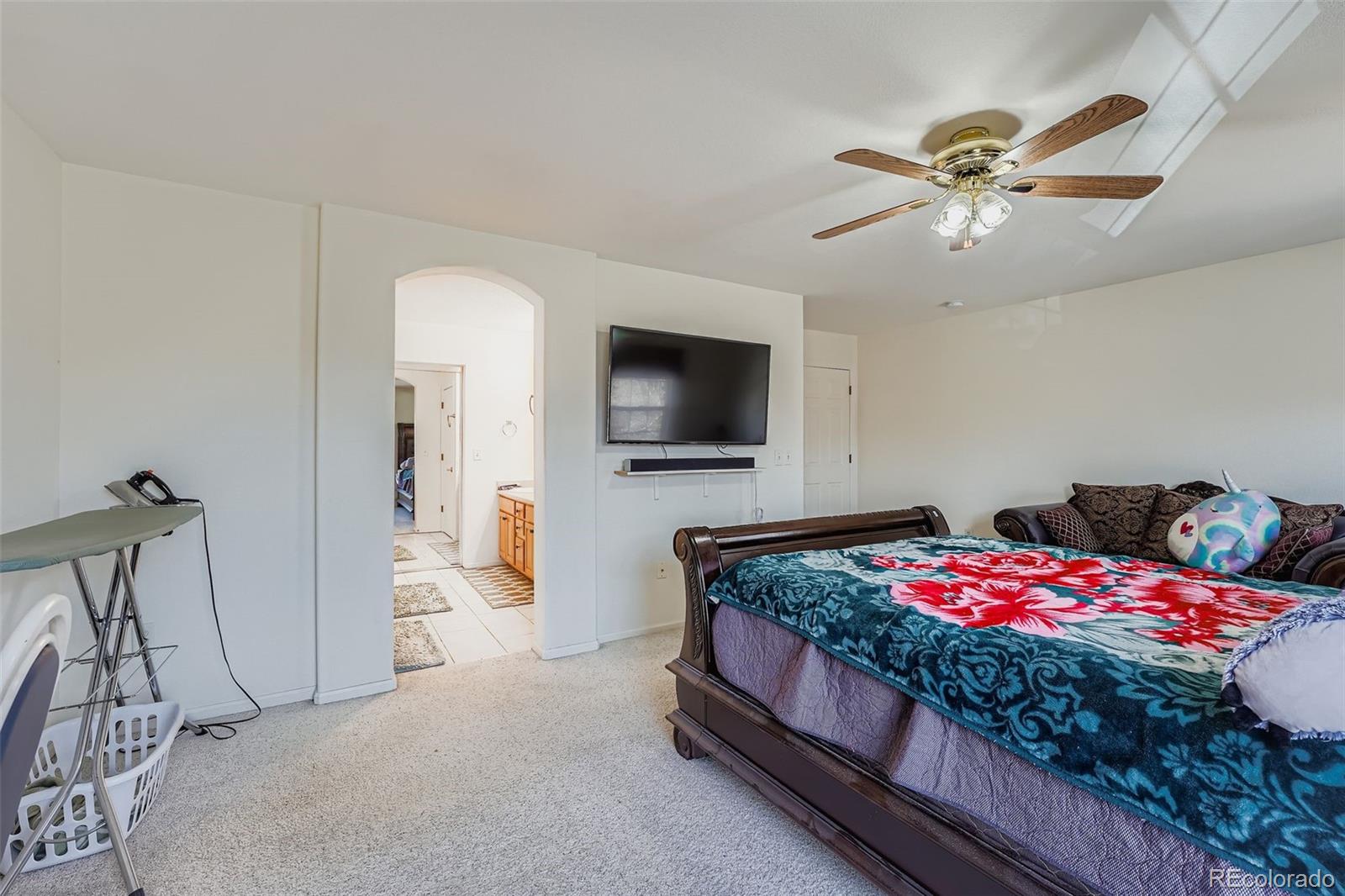 2743 South Waco Way Aurora, CO 80013 - Photo 20 of 28 a bedroom with a bed and a flat screen tv