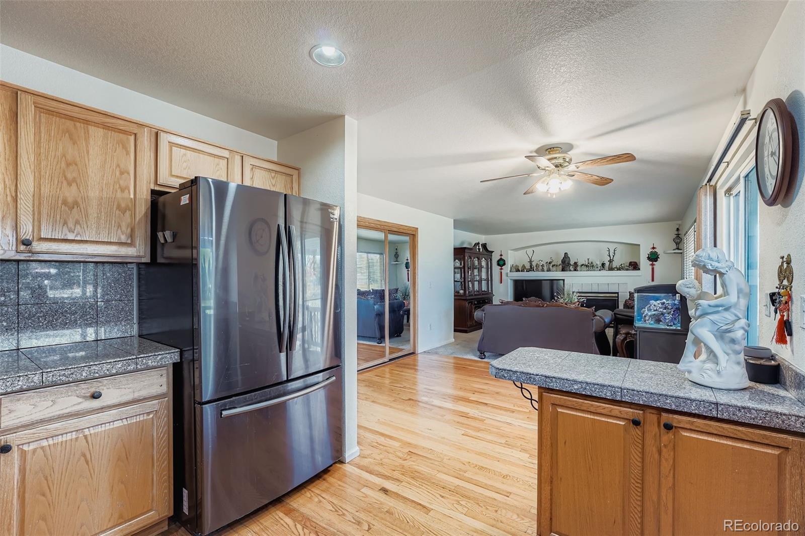 2743 South Waco Way Aurora, CO 80013 - Photo 7 of 28 a kitchen with stainless steel appliances granite countertop a refrigerator a stove a sink and a refrigerator
