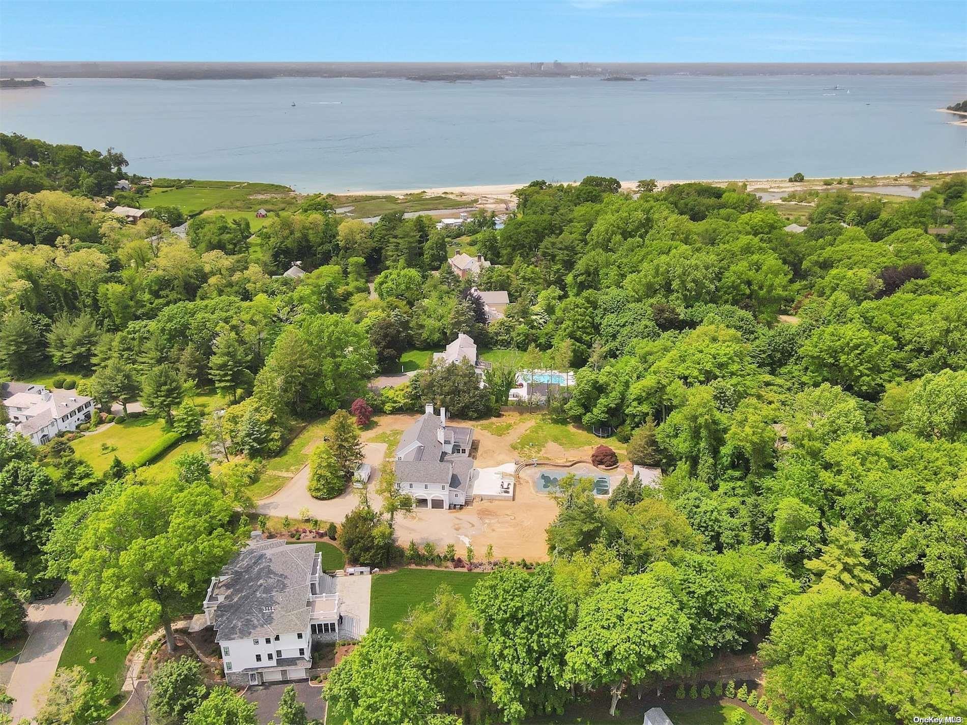 41 Cornwells Beach Road Sands Point, NY 11050 - Photo 1 of 1 an aerial view of ocean with residential house with outdoor space and trees around