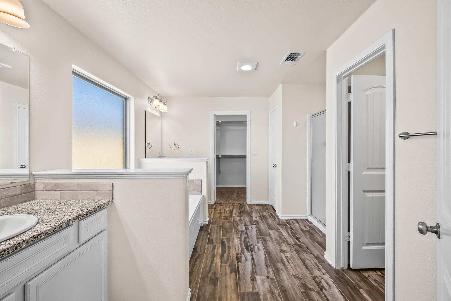 7027 37th Street Lubbock, TX 79407 - Photo 13 of 36 a bathroom with a sink and a mirror