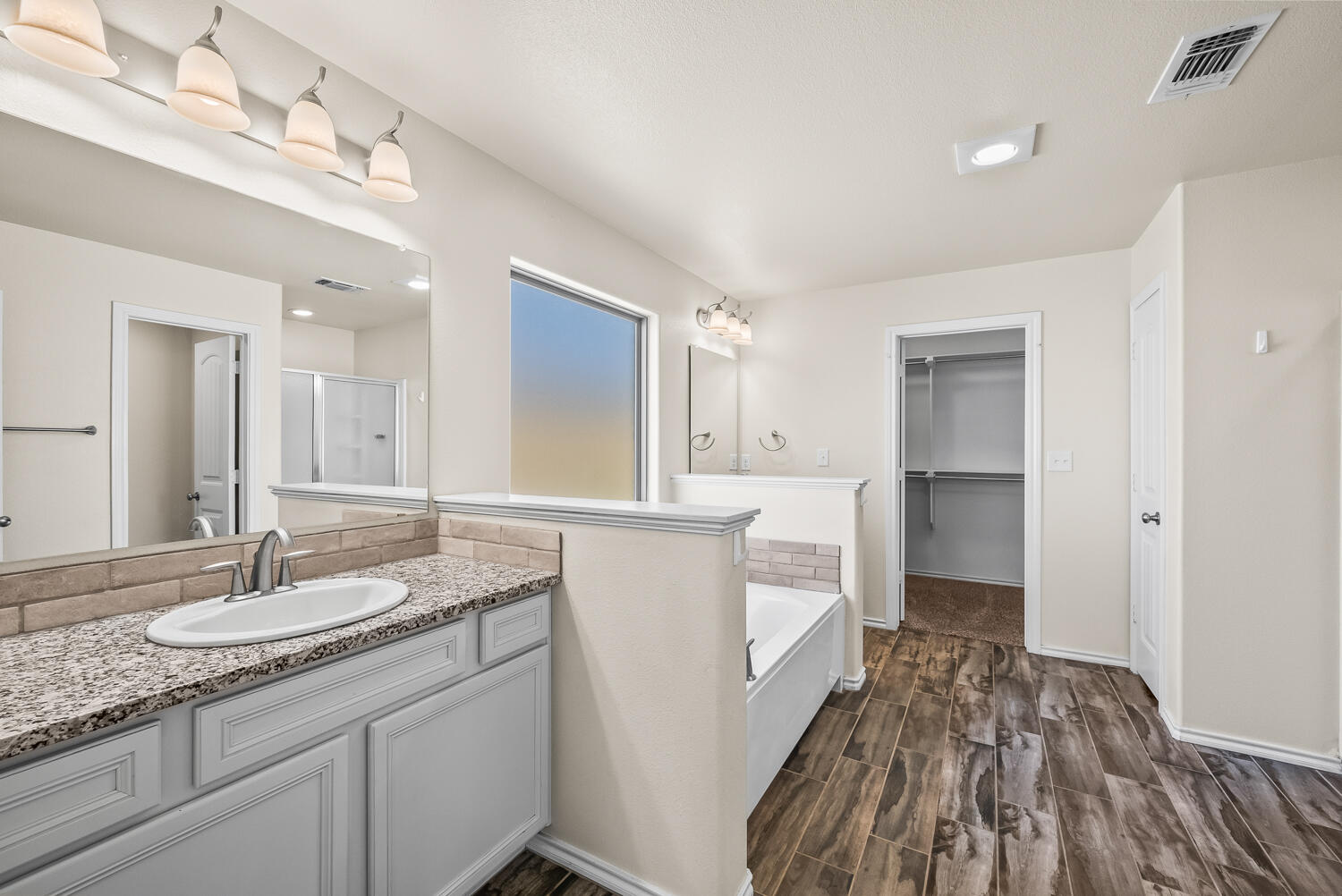 7027 37th Street Lubbock, TX 79407 - Photo 14 of 36 a bathroom with a sink and a mirror