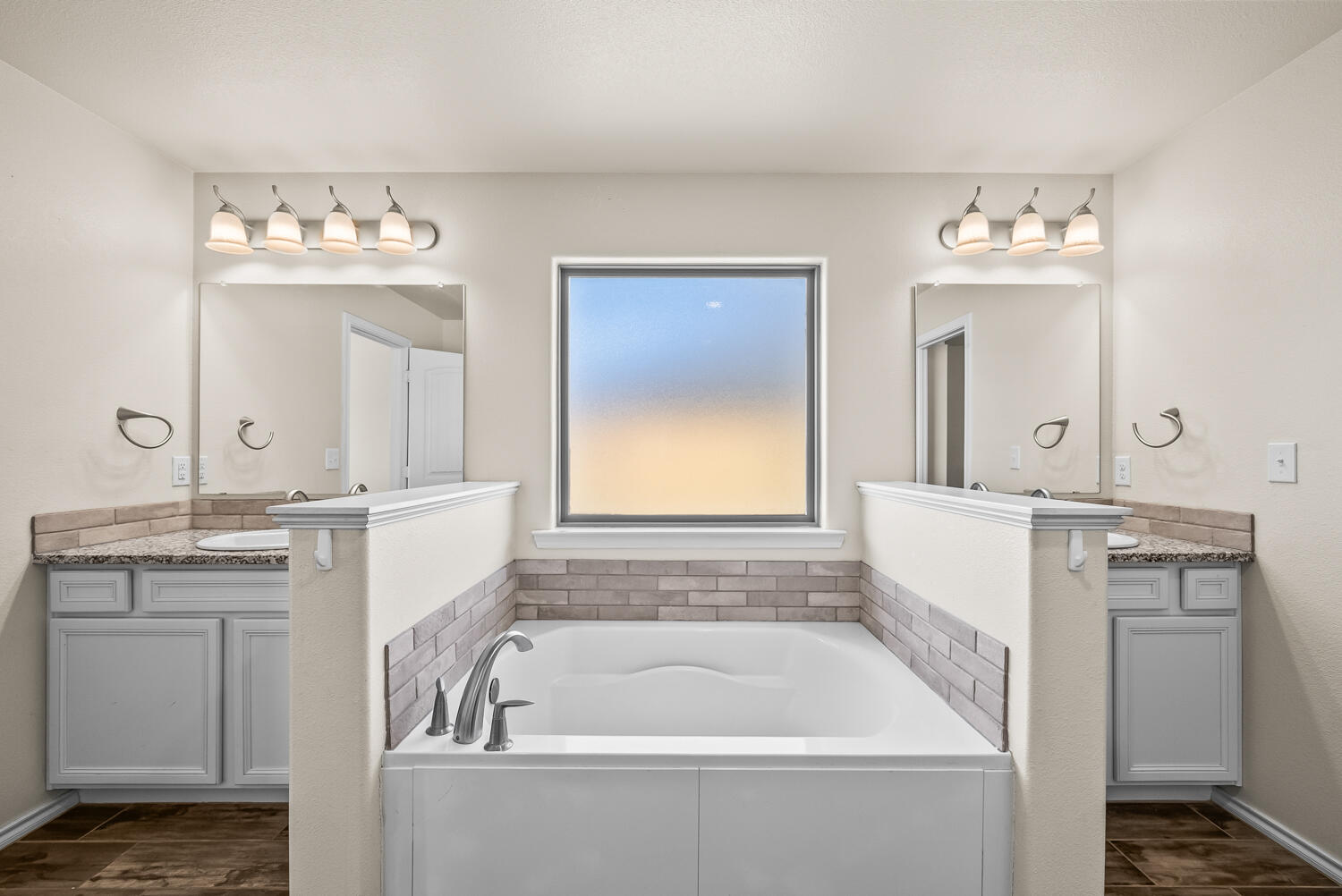 7027 37th Street Lubbock, TX 79407 - Photo 16 of 36 a bathroom with a granite countertop tub sink and mirror
