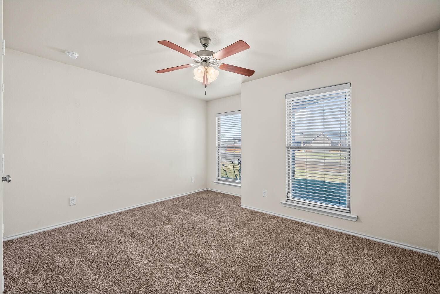 7027 37th Street Lubbock, TX 79407 - Photo 20 of 36 a view of an empty room with chandelier fan and fire place