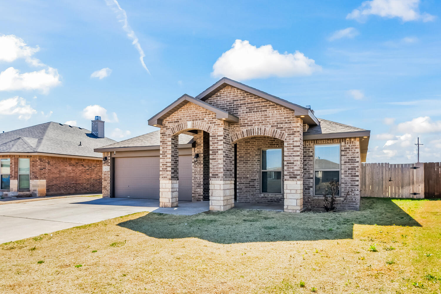 7027 37th Street Lubbock, TX 79407 - Photo 2 of 36 a view of a house with a yard and garage