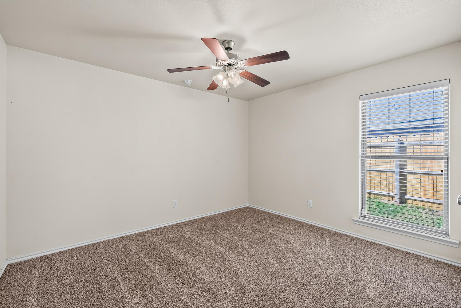 7027 37th Street Lubbock, TX 79407 - Photo 22 of 36 an empty room with windows and fan