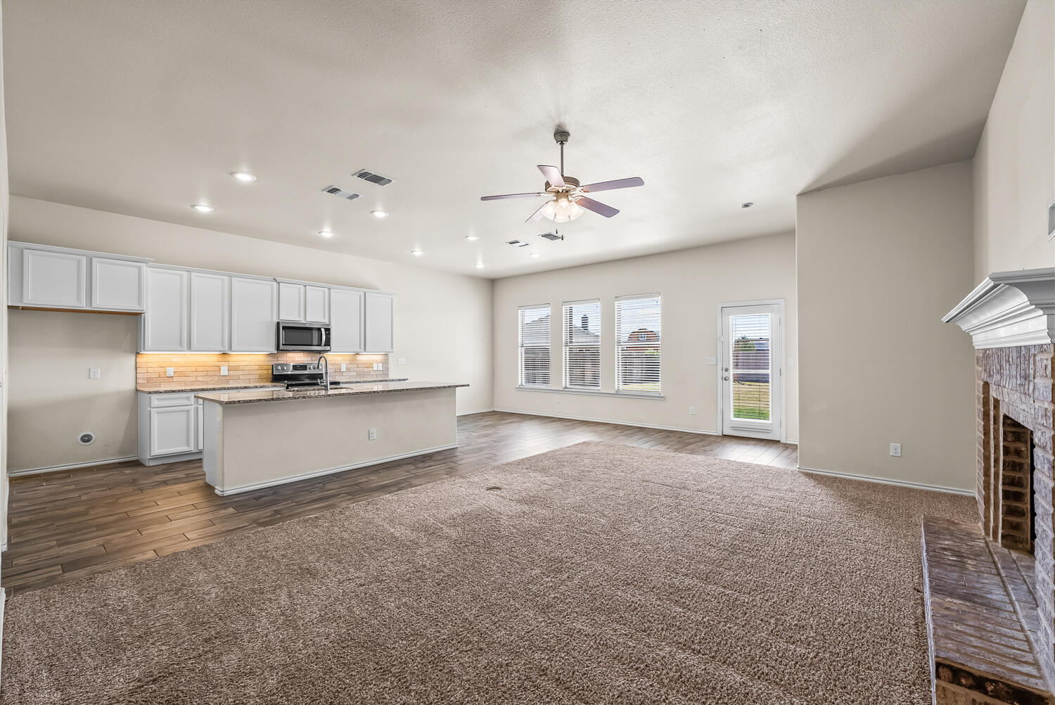7027 37th Street Lubbock, TX 79407 - Photo 5 of 36 a large kitchen with kitchen island a sink stainless steel appliances and cabinets