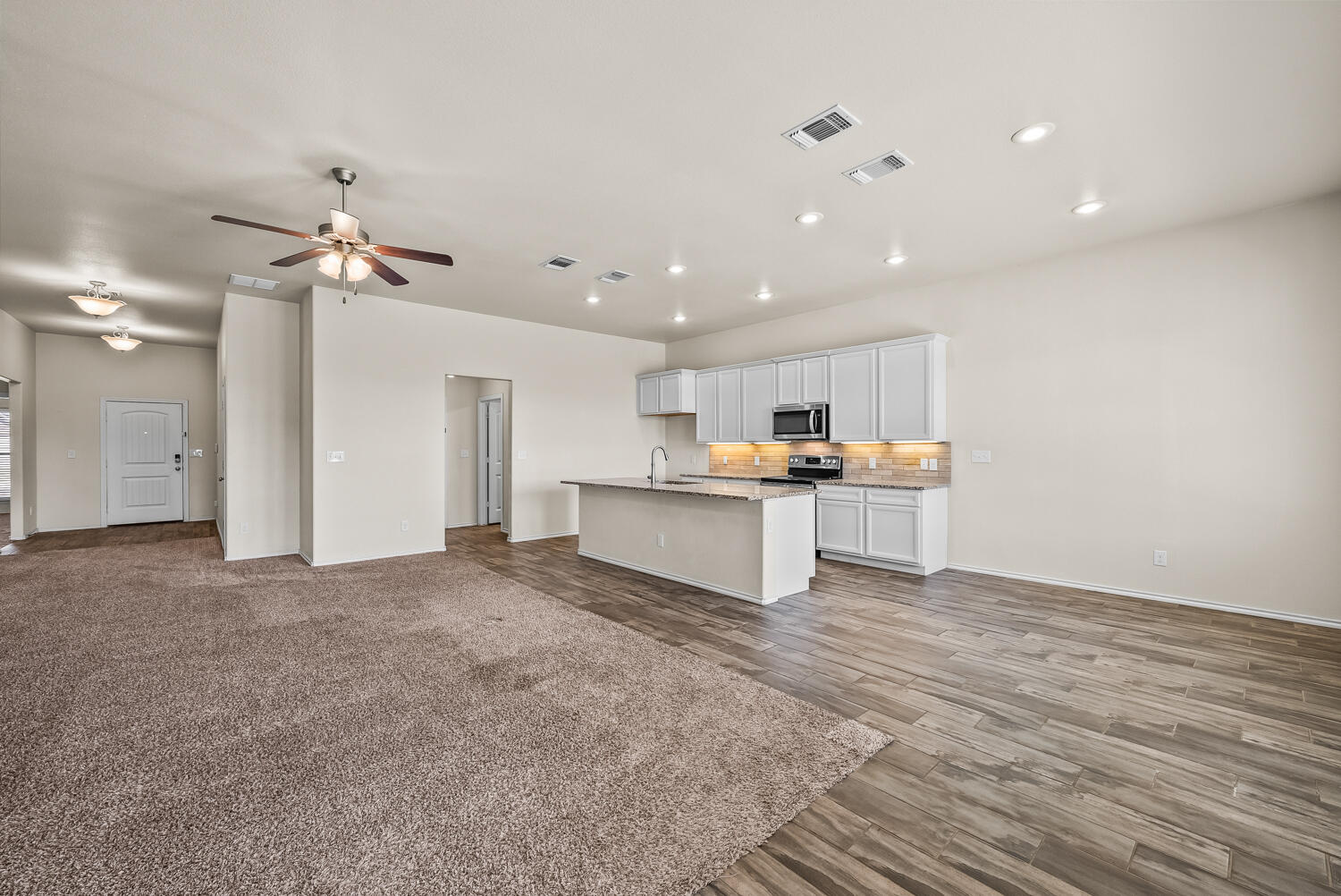 7027 37th Street Lubbock, TX 79407 - Photo 6 of 36 a view of a kitchen with a sink and a refrigerator