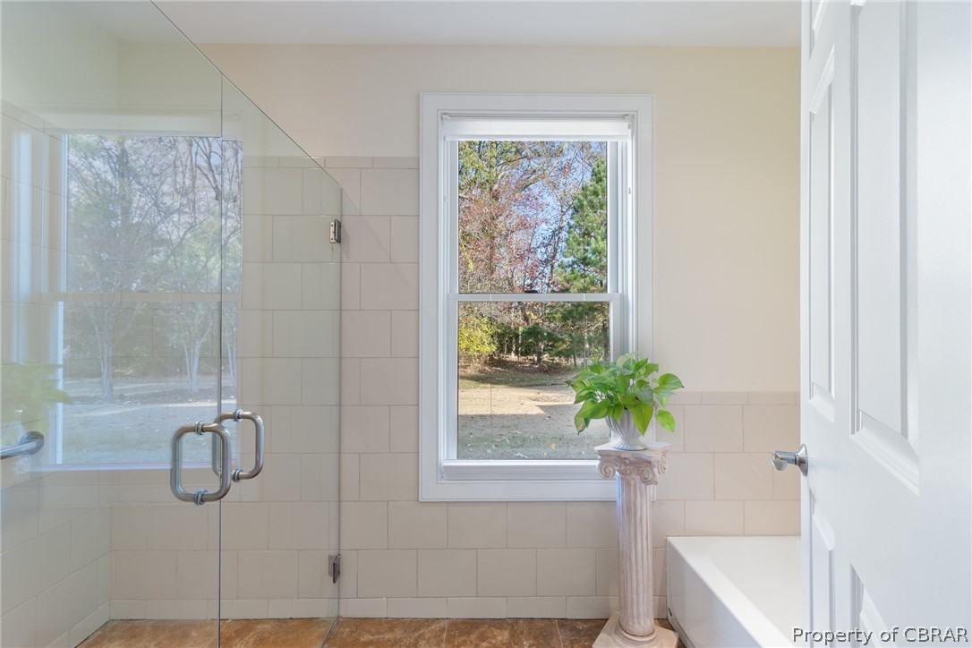 60 York Road Irvington, VA 22480 - Photo 17 of 50 Walk-in glass shower and separate tub with Travertine tile in shower and on floors
