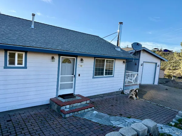 a backyard of a house with potted plants