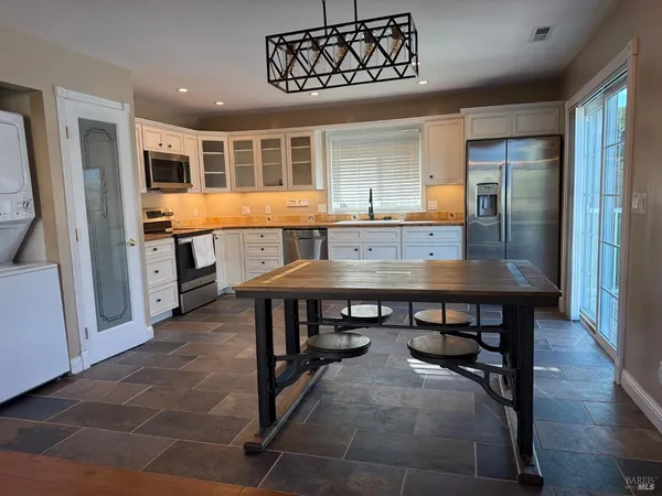 a kitchen with granite countertop a sink and a stove