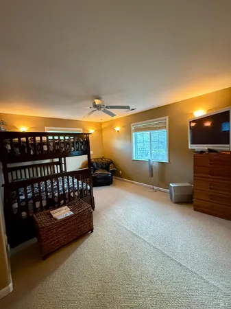 a bathroom with a granite countertop sink a toilet a mirror and bathtub
