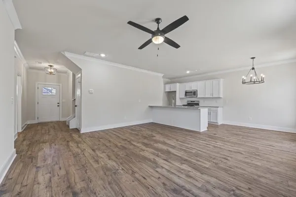 a view of kitchen with stainless steel appliances granite countertop a stove a sink and a refrigerator