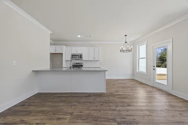 a kitchen with stainless steel appliances granite countertop a sink stove and microwave