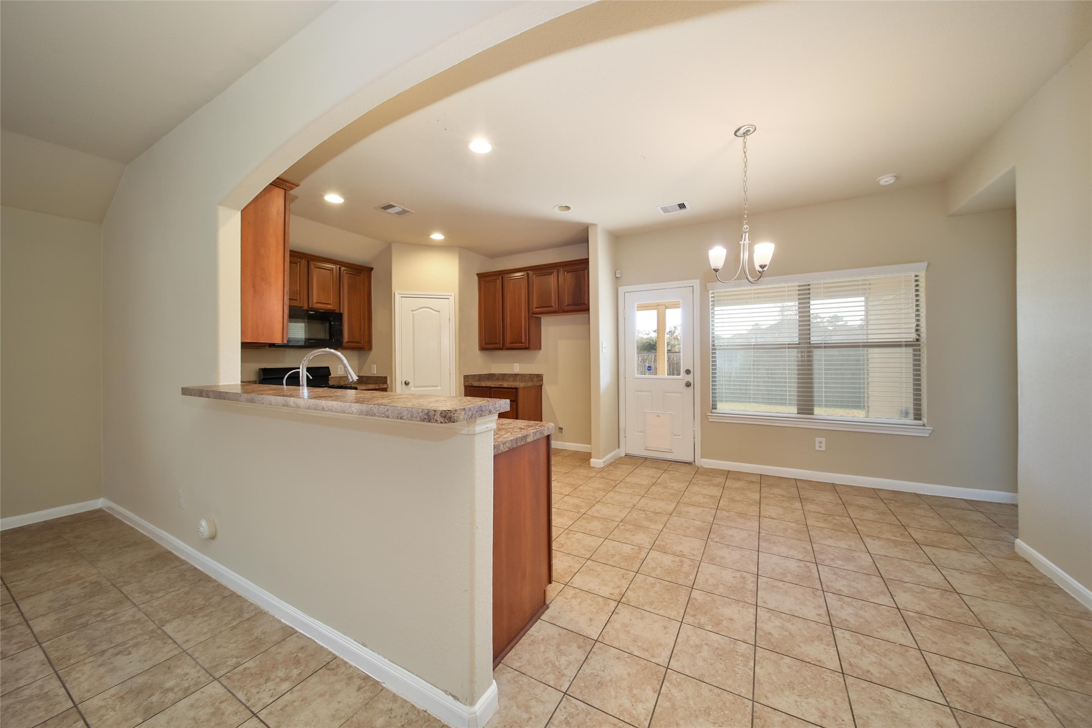 19134 Painted Boulevard Porter, TX 77365 - Photo 13 of 34 a view of a kitchen with a sink and a window