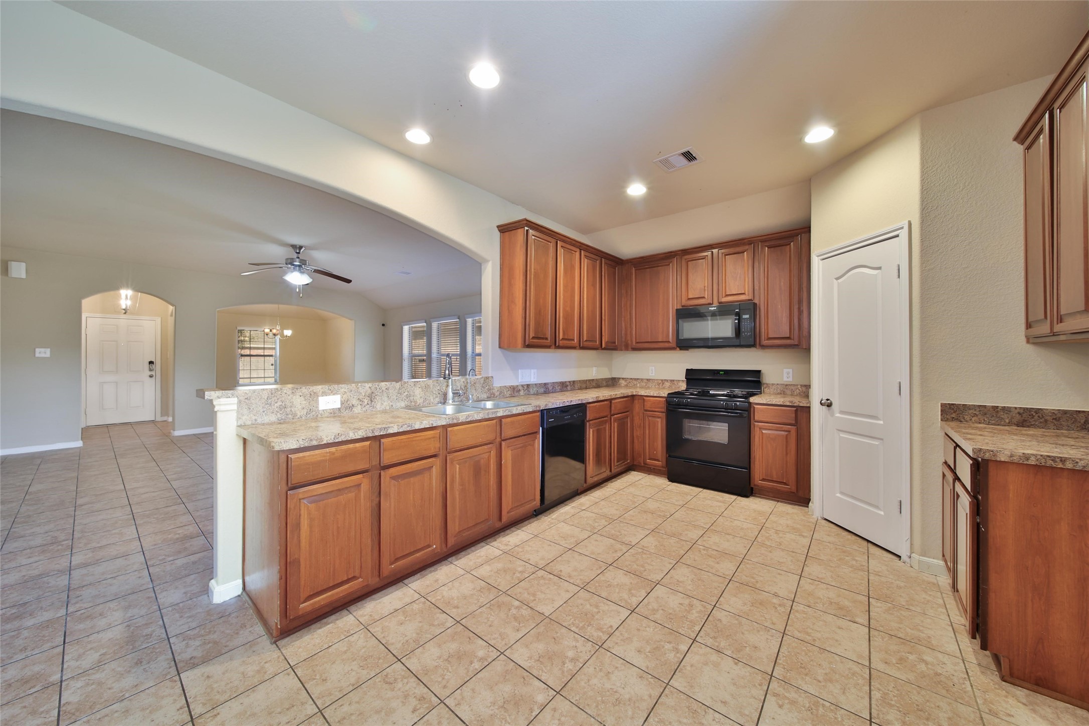 19134 Painted Boulevard Porter, TX 77365 - Photo 15 of 34 a kitchen with stainless steel appliances granite countertop a refrigerator and a stove