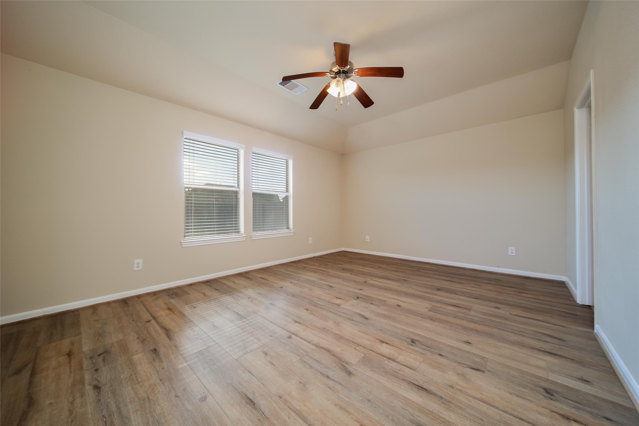19134 Painted Boulevard Porter, TX 77365 - Photo 19 of 34 a view of empty room with wooden floor and fan