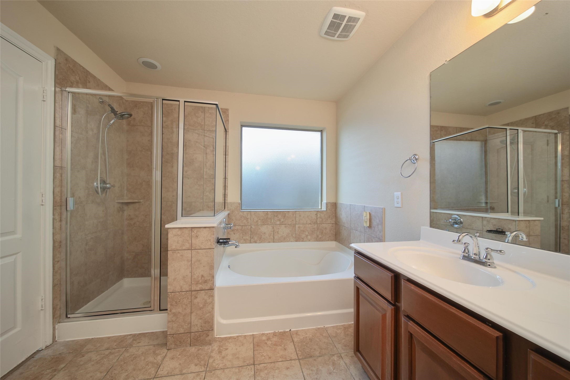 19134 Painted Boulevard Porter, TX 77365 - Photo 22 of 34 a bathroom with a tub sink shower and mirror
