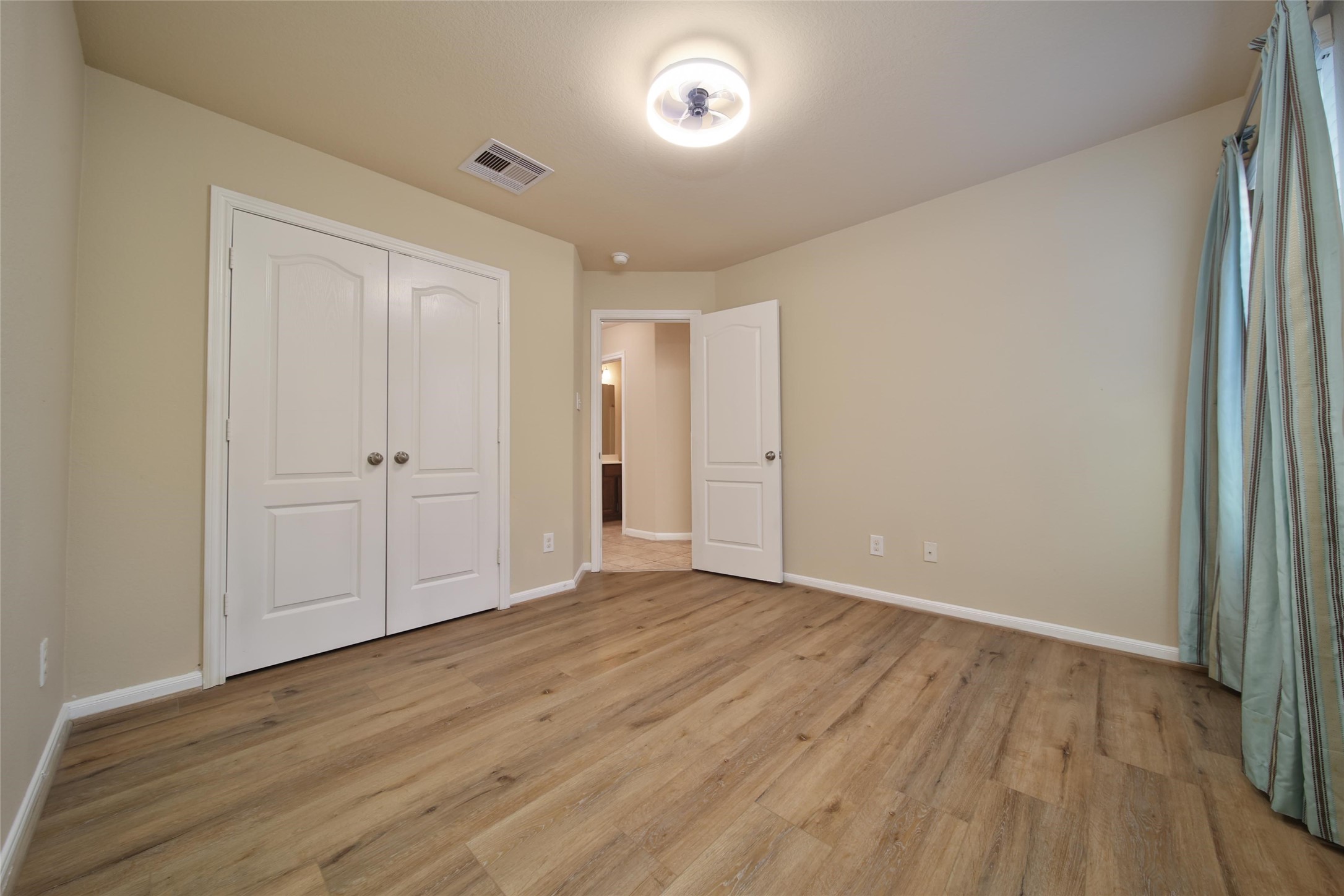 19134 Painted Boulevard Porter, TX 77365 - Photo 27 of 34 a view of an empty room with wooden floor